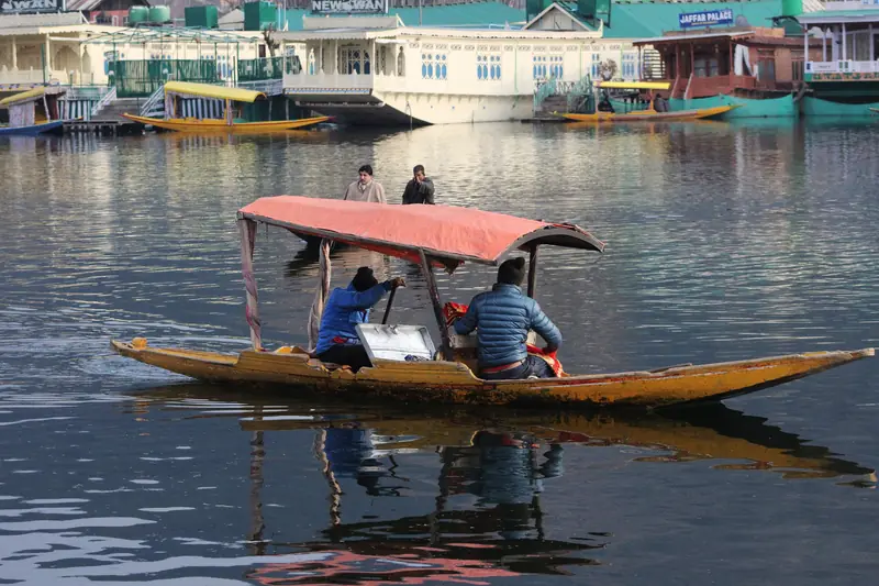 A shikara gliding across Dal Lake
